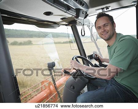 Farmer driving combine harvester View Large Photo Image Picture - Farmer driving combine harvester. Fotosearch