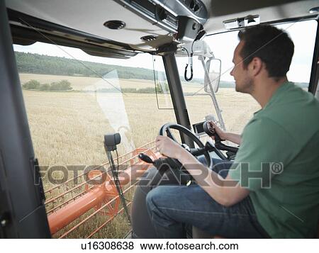 Farmer driving combine harvester View Large Photo Image Stock Photo - Farmer driving combine harvester. Fotosearch