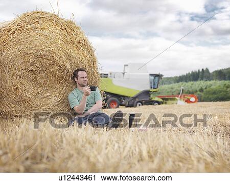 Farmer taking a break during harvesting View Large Photo Image Stock Image - Farmer taking a break during harvesting. Fotosearch