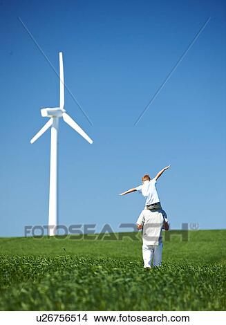 Farther and son, field, wind turbine View Large Photo Image Picture - Farther and son, field, wind turbine. Fotosearch