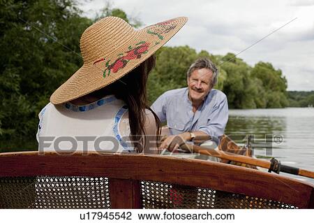 Stock Image - Father and daughter on a vintage boat. Fotosearch