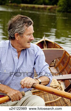 Stock Photo - Father and daughter on a vintage boat. Fotosearch