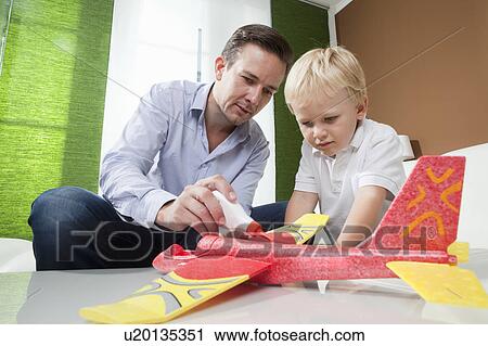 Father and son fixing toy plane View Large Photo Image Stock Image - Father and son fixing toy plane. Fotosearch