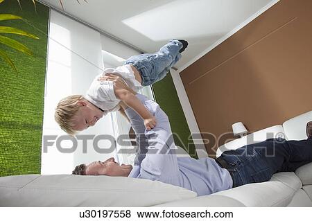 Stock Photo - Father and son kidding around. Fotosearch
