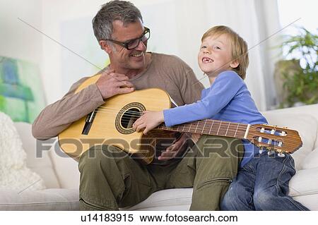 Father and son with guitar View Large Photo Image Stock Photography - Father and son with guitar. Fotosearch