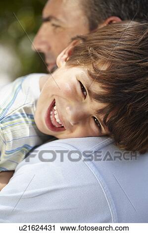 Father carrying son on his shoulder View Large Photo Image Stock Image - Father carrying son on his shoulder. Fotosearch