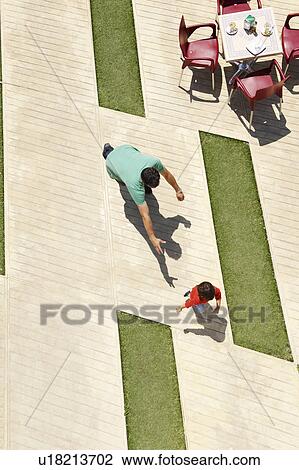 Stock Image - Father chasing young son. Fotosearch
