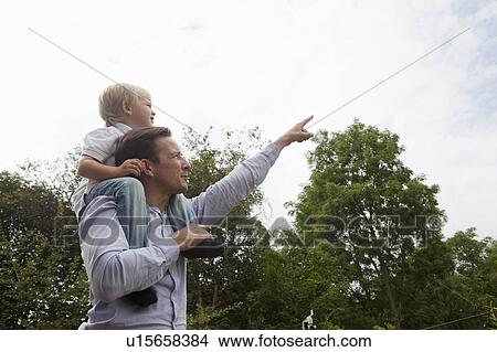 Father pointing aout at something View Large Photo Image Picture - Father pointing aout at something. Fotosearch