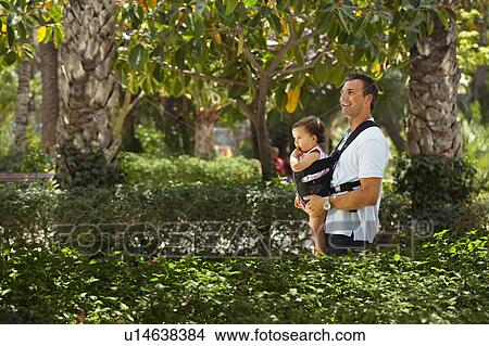 Father walking with baby in park View Large Photo Image Picture - Father walking with baby in park. Fotosearch