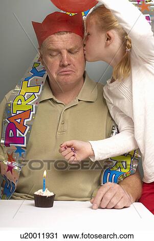 Father with small cake being kissed View Large Photo Image Stock Image - Father with small cake being kissed. Fotosearch