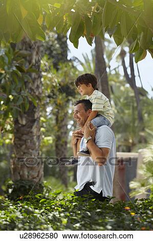 Father with son on his shoulders View Large Photo Image Stock Image - Father with son on his shoulders. Fotosearch