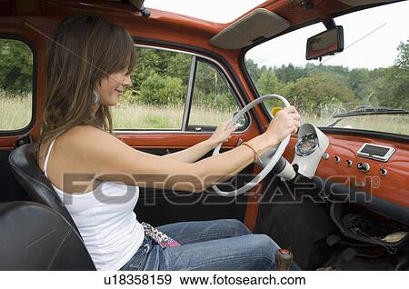 Stock Photo - Female driving car. Fotosearch