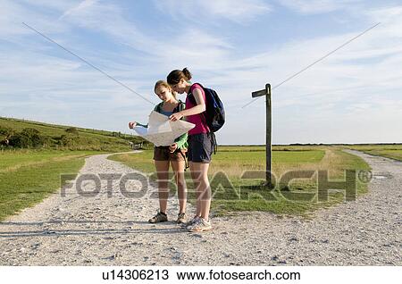 Female hikers check route on map View Large Photo Image Stock Image - Female hikers check route on map. Fotosearch