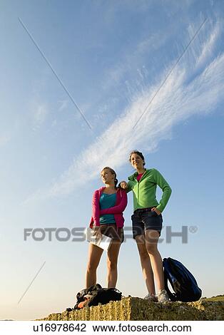 Female hikers relax after long trex View Large Photo Image Stock Image - Female hikers relax after long trex. Fotosearch