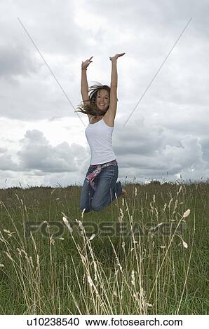 Female jumping in field View Large Photo Image Stock Image - Female jumping in field. Fotosearch