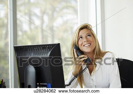 Female office worker on phone View Large Photo Image Stock Image - Female office worker on phone. Fotosearch