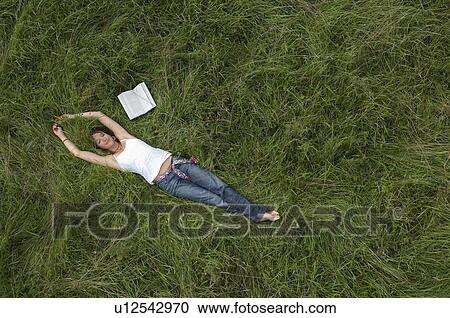 Female relaxing in field View Large Photo Image Stock Image - Female relaxing in field. Fotosearch