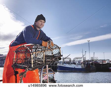 Stock Photograph - Fisherman with lobster pot. Fotosearch