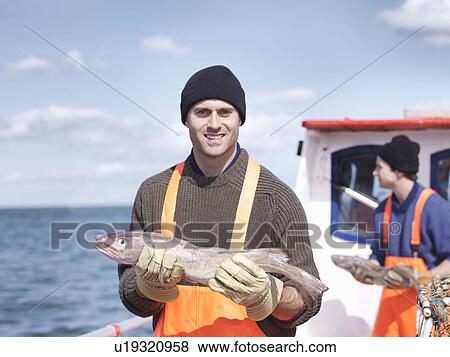 Fishermen on boat holding fish View Large Photo Image Stock Photo - Fishermen on boat holding fish. Fotosearch