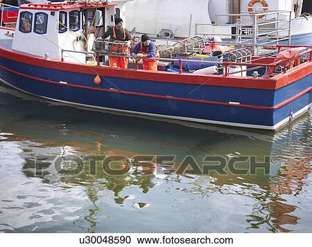 Fishermen on boat in harbour View Large Photo Image Stock Image - Fishermen on boat in harbour. Fotosearch