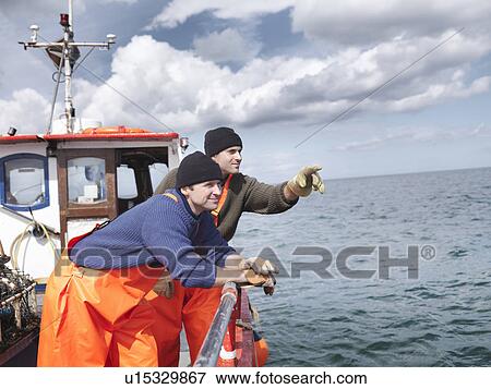 Fishermen on boat looking out to sea View Large Photo Image Stock Photo - Fishermen on boat looking out to sea. Fotosearch