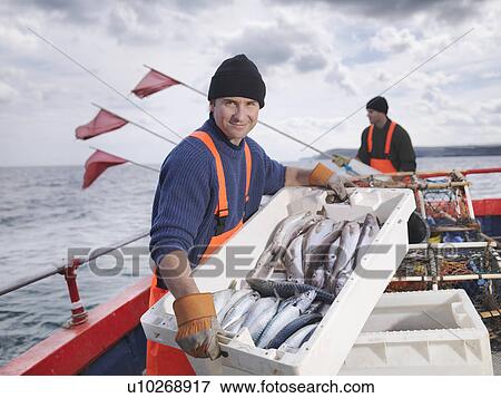 Fishermen on boat with catch of fish View Large Photo Image Stock Photo - Fishermen on boat with catch of fish. Fotosearch