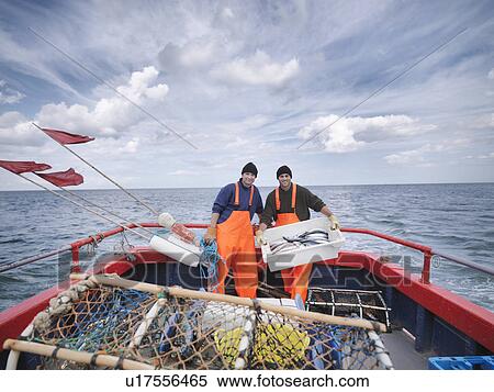 Stock Photography - Fishermen on boat with fish. Fotosearch