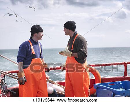 Fishermen on fishing boat talking View Large Photo Image Picture - Fishermen on fishing boat talking. Fotosearch