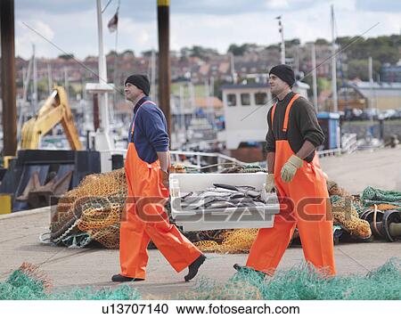 Fishermen with box of fish on harbour View Large Photo Image Stock Image - Fishermen with box of fish on harbour. Fotosearch