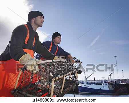 Stock Photography - Fishermen with lobster pot. Fotosearch