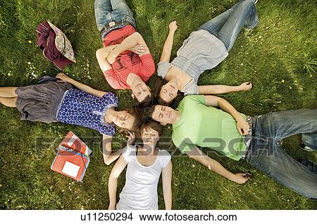 Five students relaxing in a park View Large Photo Image Picture - Five students relaxing in a park. Fotosearch