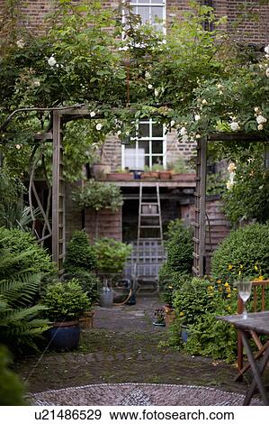 Stock Photo - Flowers in vases and an English Garden. Fotosearch