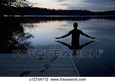 Footsteps on jetty, man in still lake View Large Photo Image Stock Image - Footsteps on jetty, man in still lake. Fotosearch