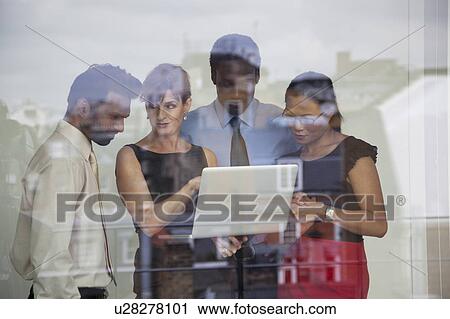 Four business people using laptop View Large Photo Image Stock Image - Four business people using laptop. Fotosearch
