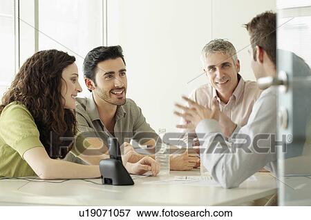 Four people in discussion View Large Photo Image Stock Photo - Four people in discussion. Fotosearch