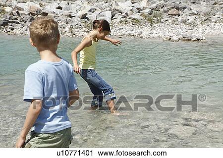 Stock Image - Free Time by the River in the Mountains. Fotosearch