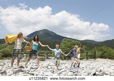 Stock Image - Free Time by the River in the Mountains. Fotosearch