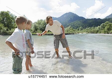 Stock Image - Free Time by the River in the Mountains. Fotosearch