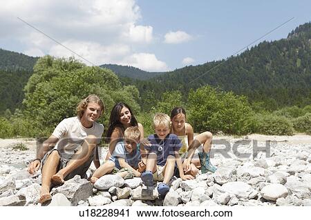 Stock Image - Free Time by the River in the Mountains. Fotosearch