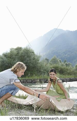 Stock Photo - Free Time by the River in the Mountains. Fotosearch