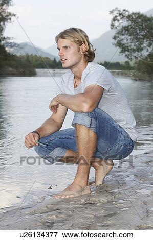 Stock Photo - Free Time by the River in the Mountains. Fotosearch