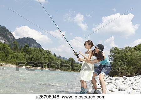 Stock Photo - Free Time by the River in the Mountains. Fotosearch
