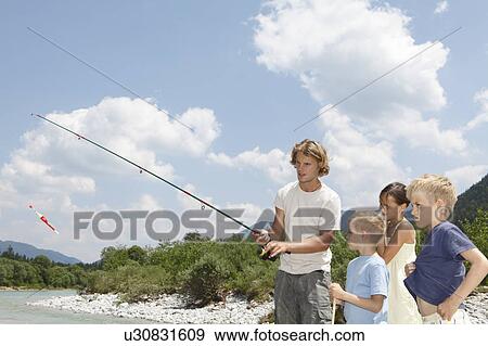 Stock Photo - Free Time by the River in the Mountains. Fotosearch