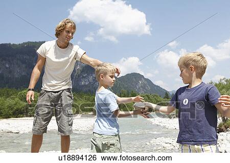 Stock Photograph - Free Time by the River in the Mountains. Fotosearch