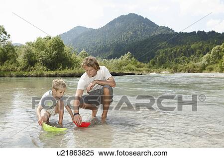 Stock Photography - Free Time by the River in the Mountains. Fotosearch