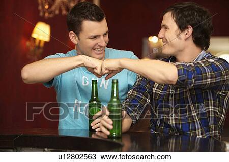 Stock Image - Friends in a bar / restaurant. Fotosearch