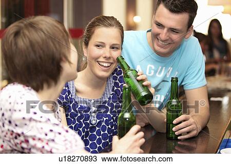 Friends in a bar / restaurant View Large Photo Image Stock Image - Friends in a bar / restaurant. Fotosearch