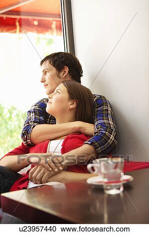 Stock Image - Friends in a bar / restaurant. Fotosearch