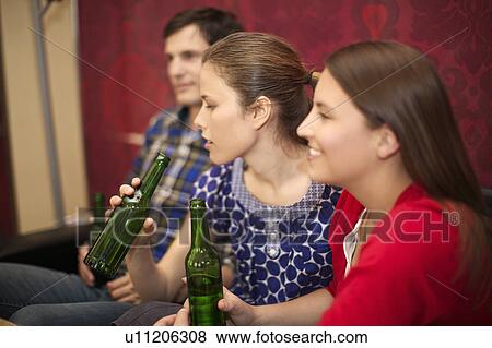 Stock Photo - Friends in a bar / restaurant. Fotosearch