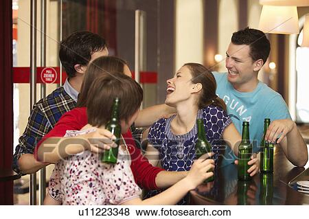 Friends in a bar / restaurant View Large Photo Image Stock Photo - Friends in a bar / restaurant. Fotosearch
